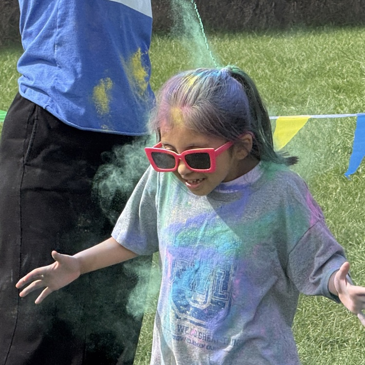 students run with color powder all over them