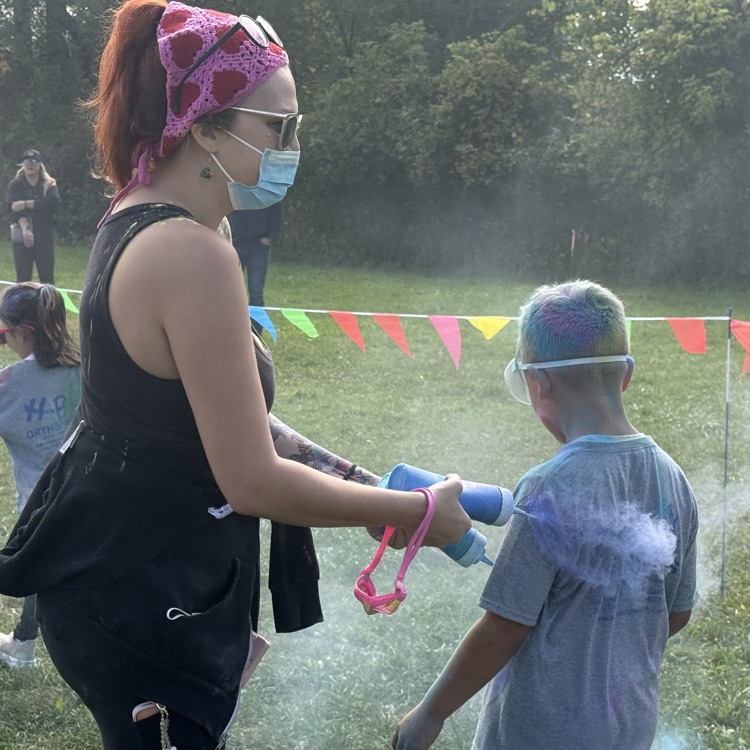 students run with color powder all over them
