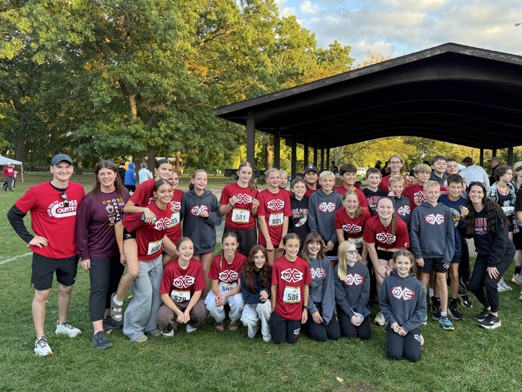 team phots of cross country in red jerseys outside a park pavilion 