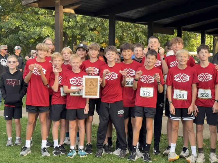 group photo of cross country team in red shirts
