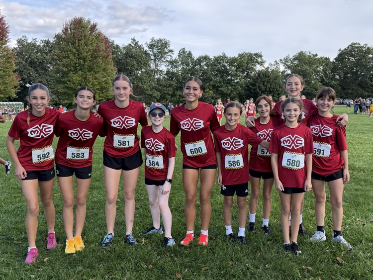 group of cross country runners I. red shirts stand outside