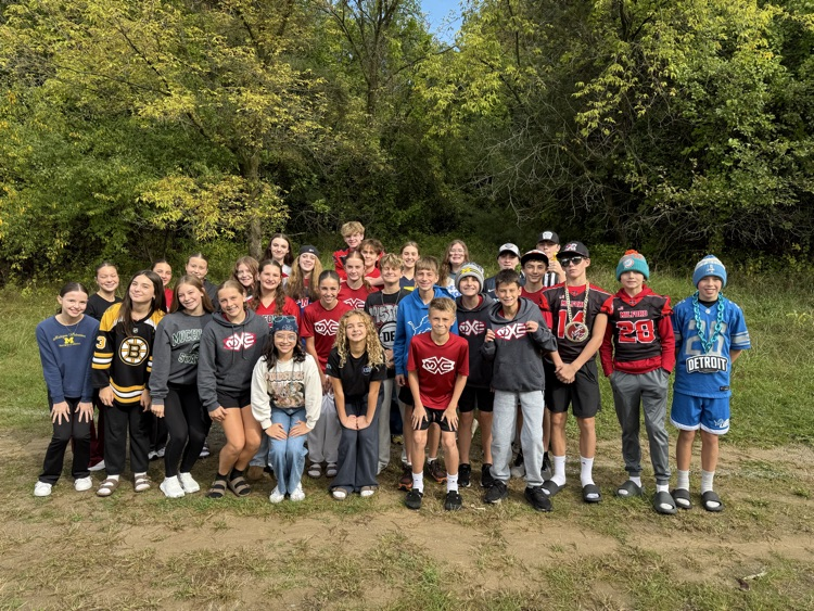 group shot of students wearing their favorite sports team in a group outside