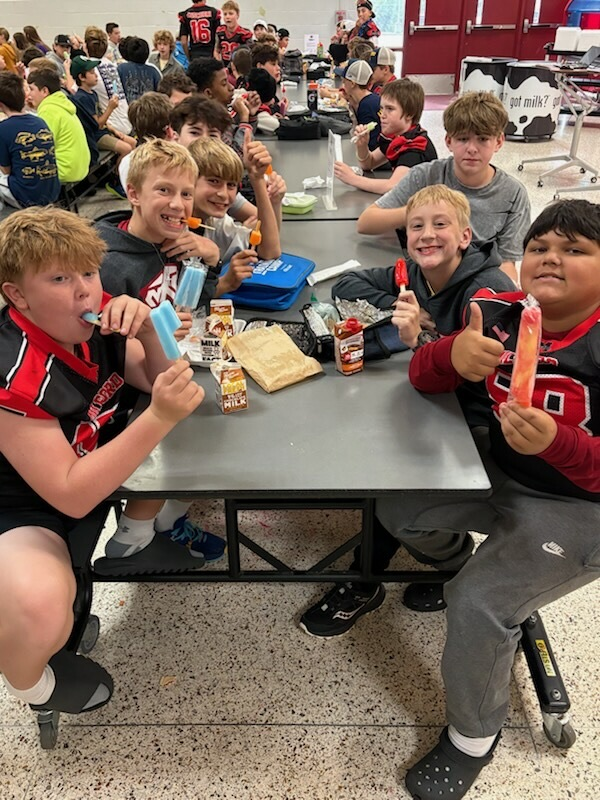 students eating popsicles in the cafeteria 