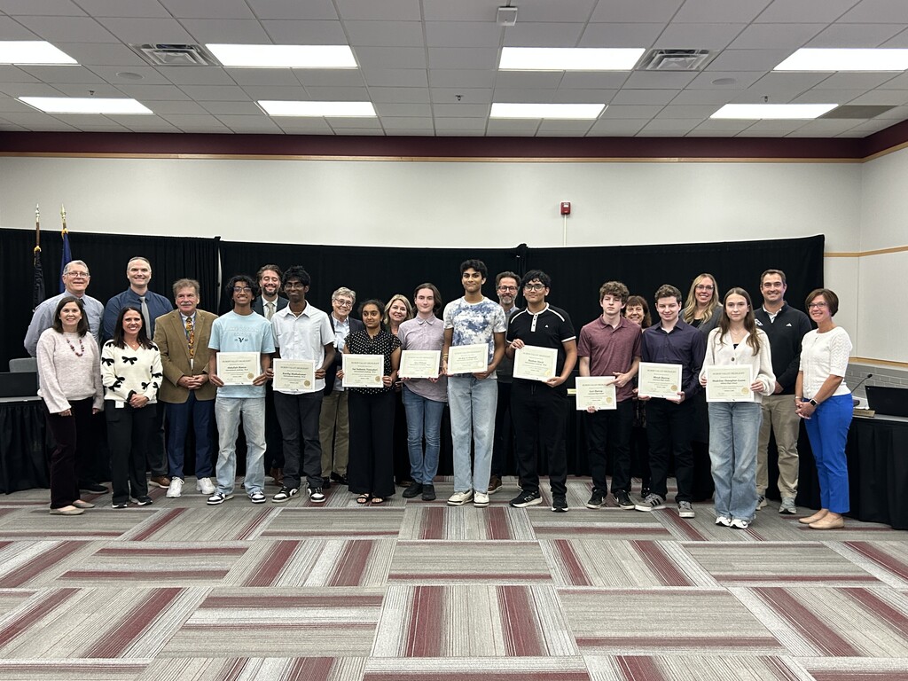 Photo of several teens & adults standing and posing for a picture