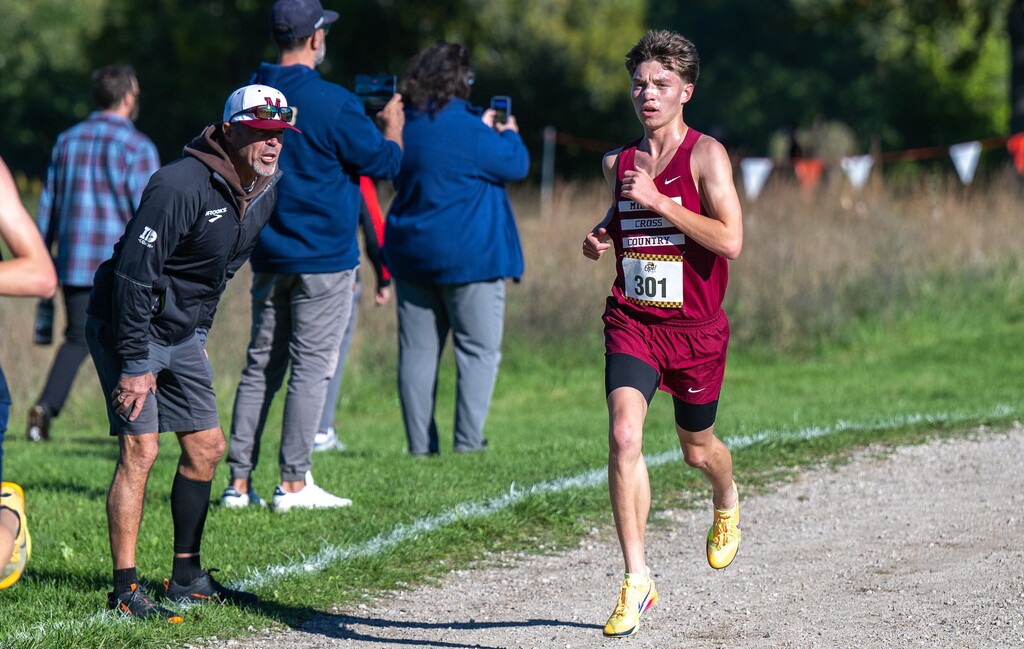 Photo of male cross country runner taking part in a race