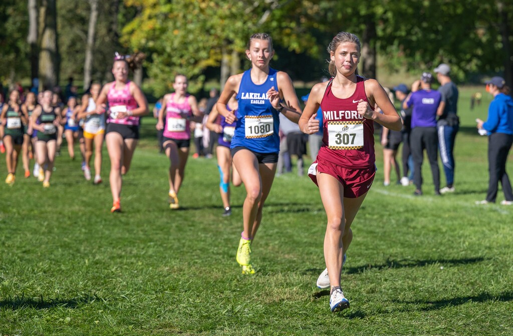 Photo of several female cross country runners taking part in a race