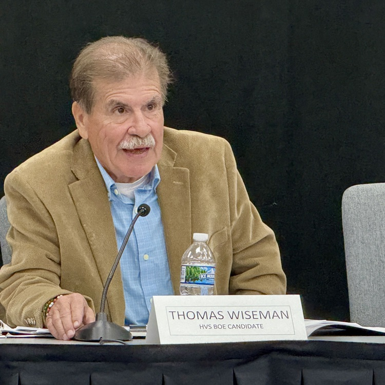 photo of a man sitting at a table talking