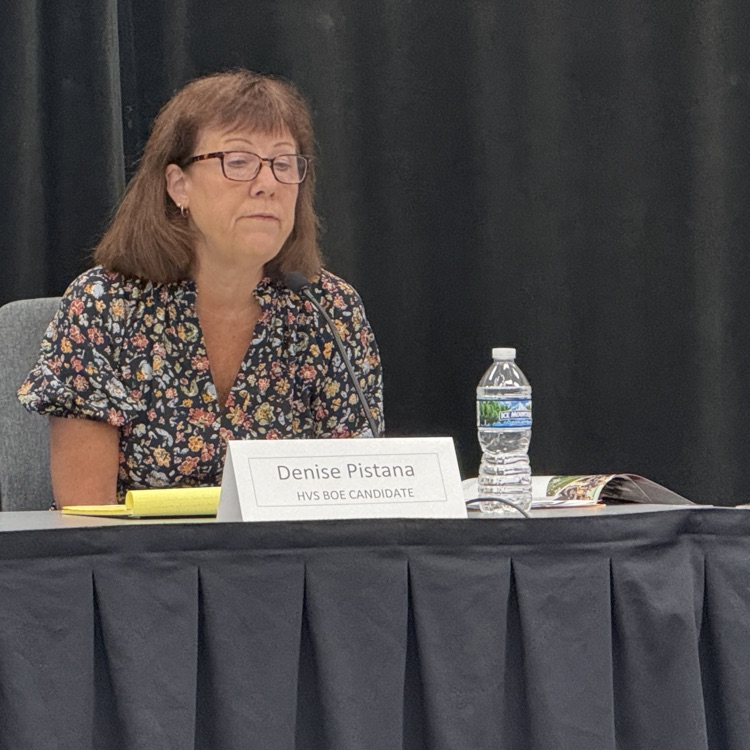 photo of a woman sitting at a table talking
