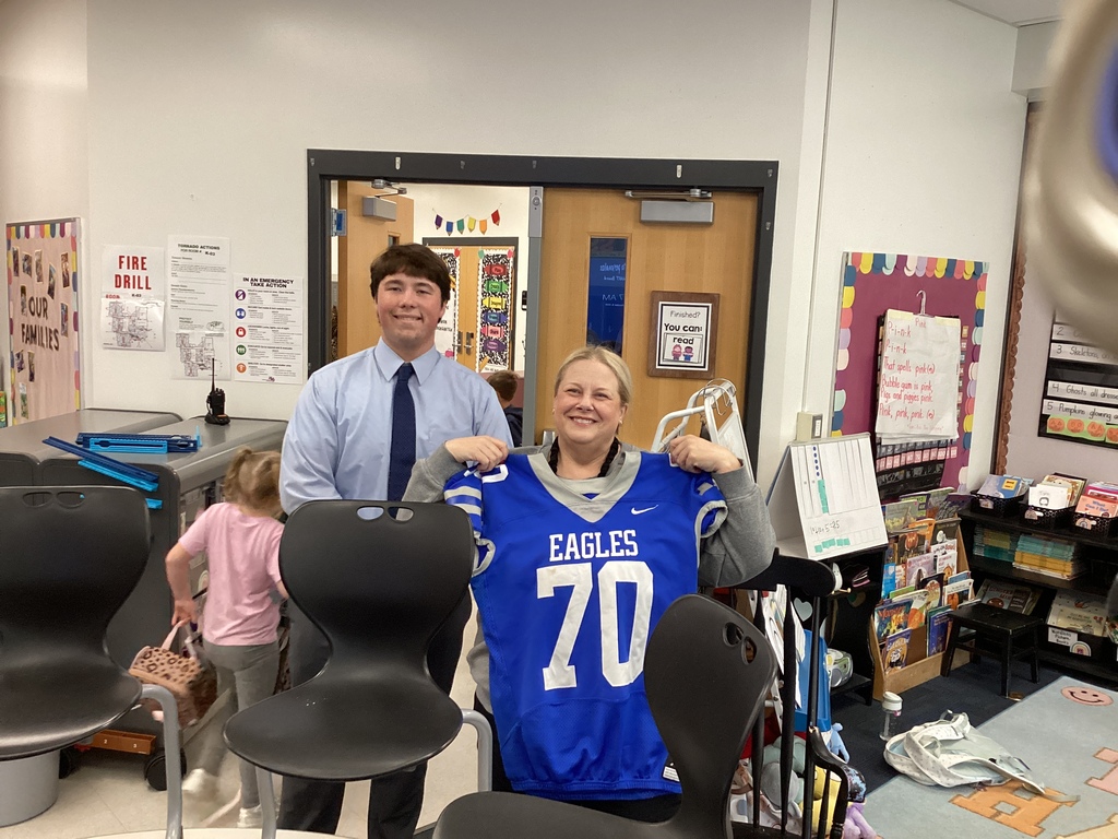 Paura rosing receiving a jersey from senior Nate Johnson. 