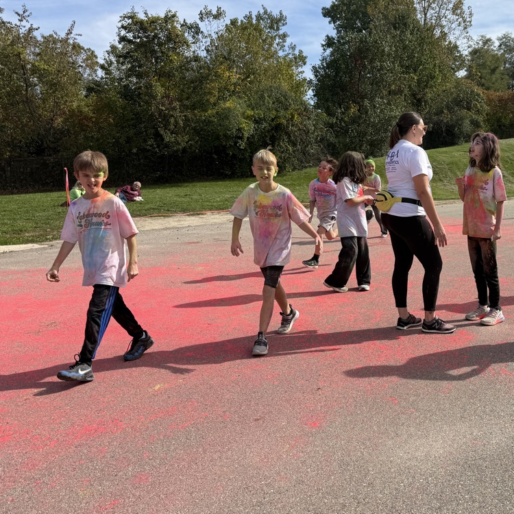 school kids covered in colored powder walking outside