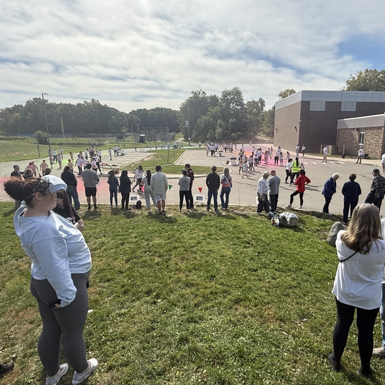 school kids covered in colored powder walking outside