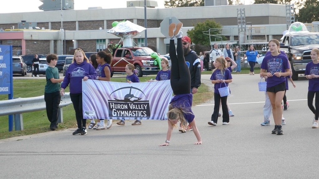 Girl walking on her hands in a parade