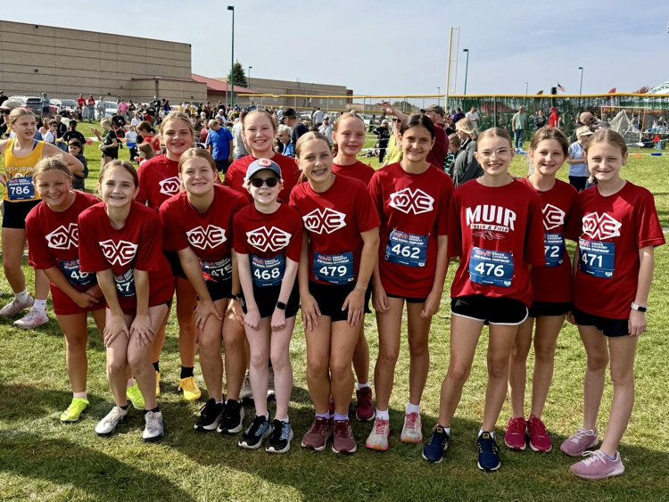 group photo of cross country runners in red Muir shirts