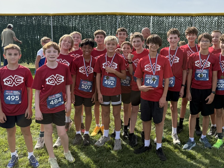 group photo of cross country runners in red Muir shirts