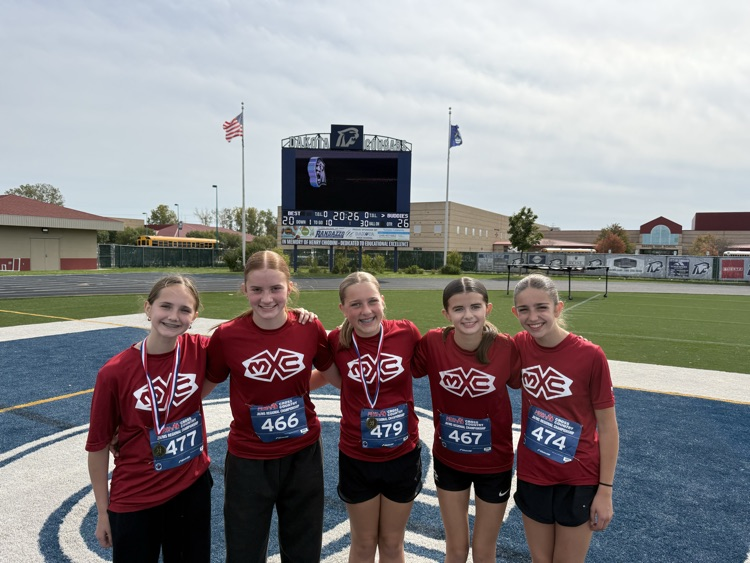 group photo of Muir cross country runners in red shirts