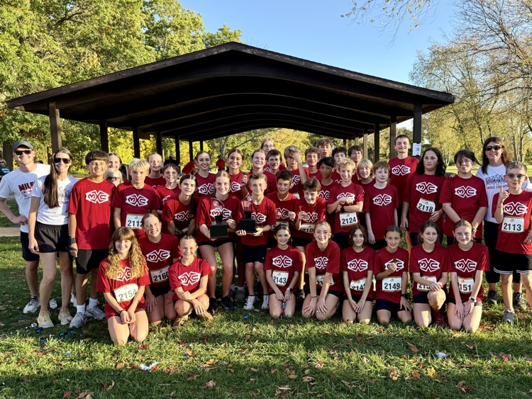 group photo of cross country team in red Muir shirts.