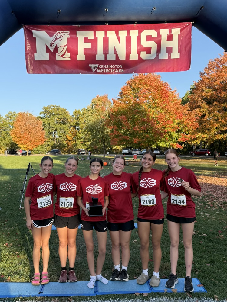 six cross country runners stand together at the finish line