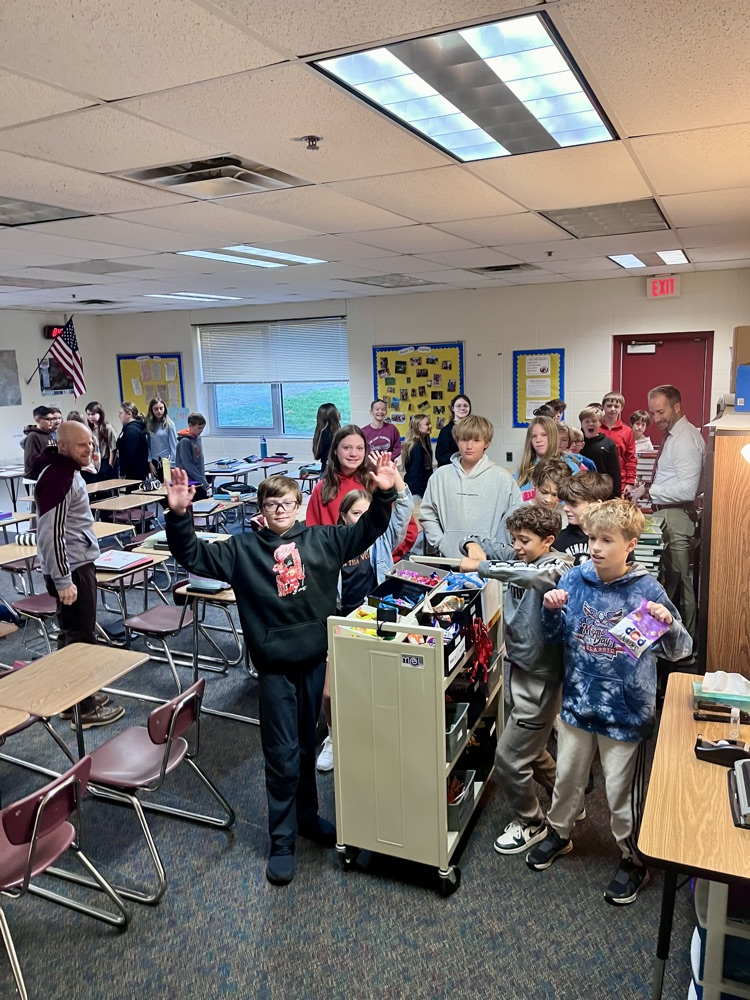 students get treats off of a rolling cart in their classroom 