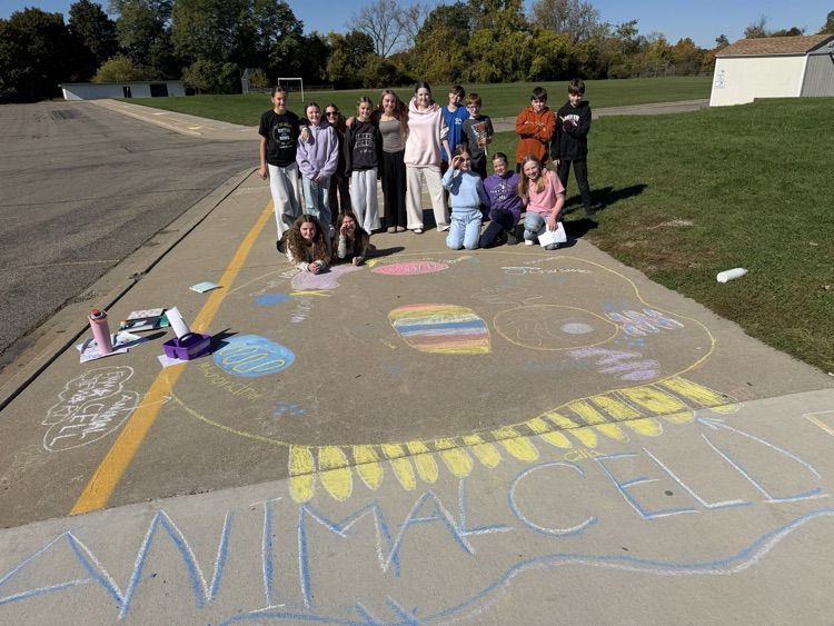 students stand near their chalk drawing outside Muir