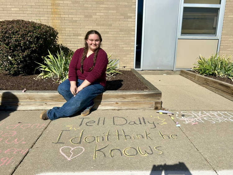 students stand near their chalk drawing outside Muir