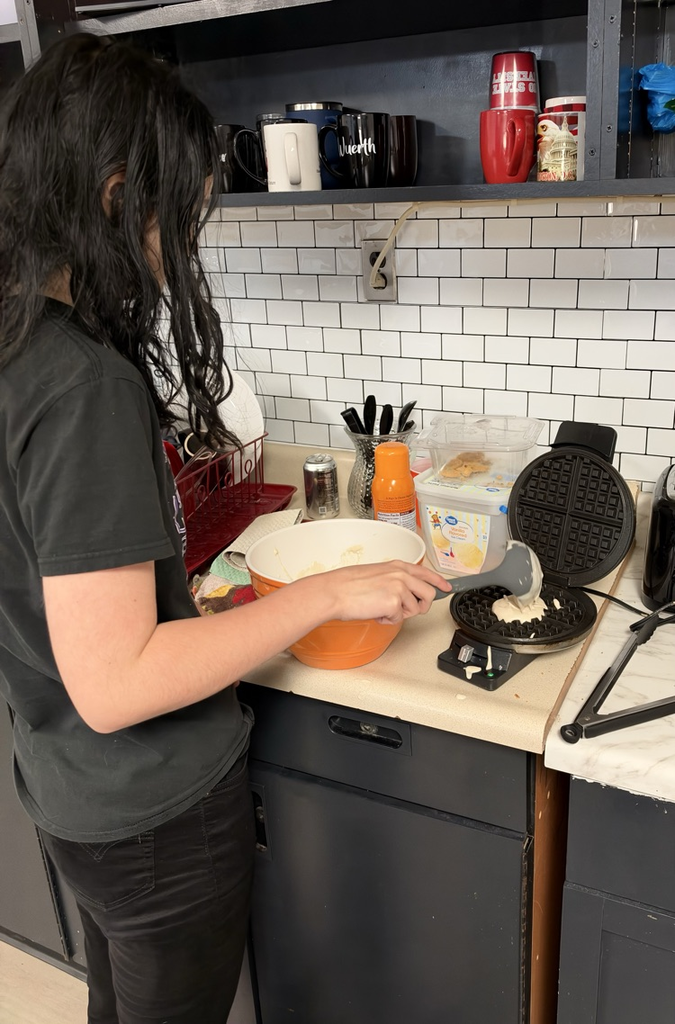 a student mixes ingredients 