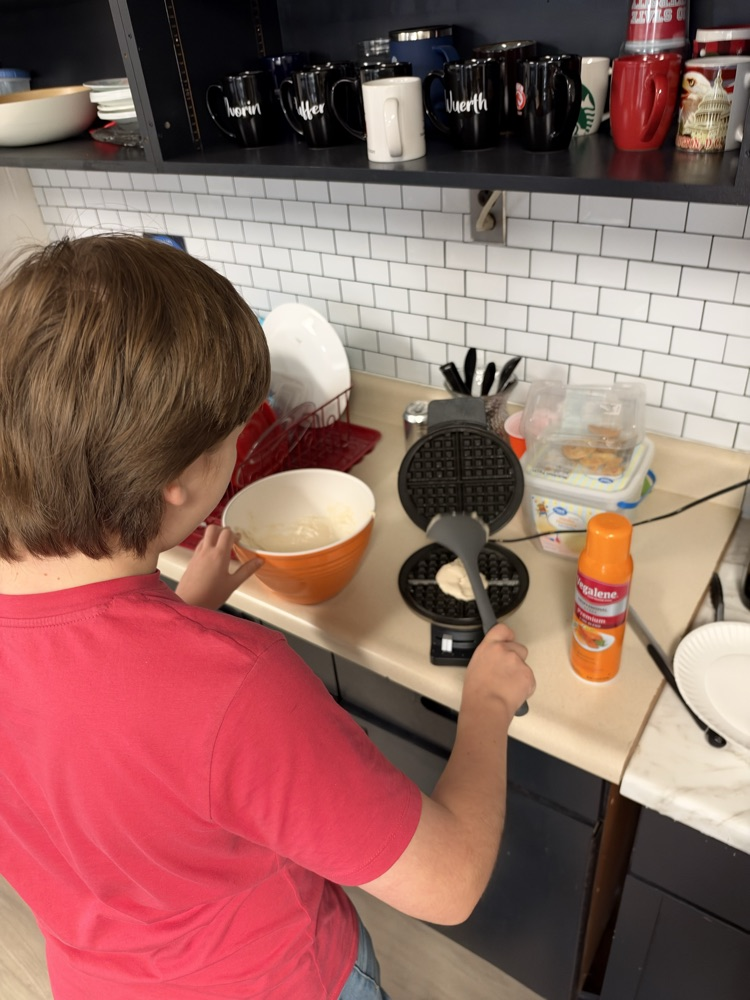 a student mixes ingredients 
