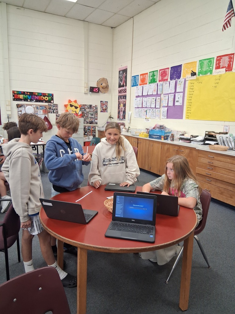 Students work collaboratively at around table