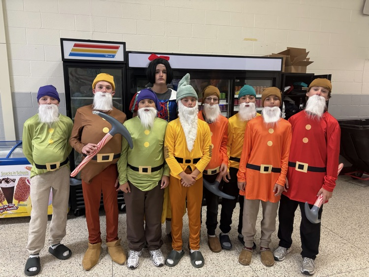 students stand in a group wearing Snow White and the Seven Dwarfs costumes 