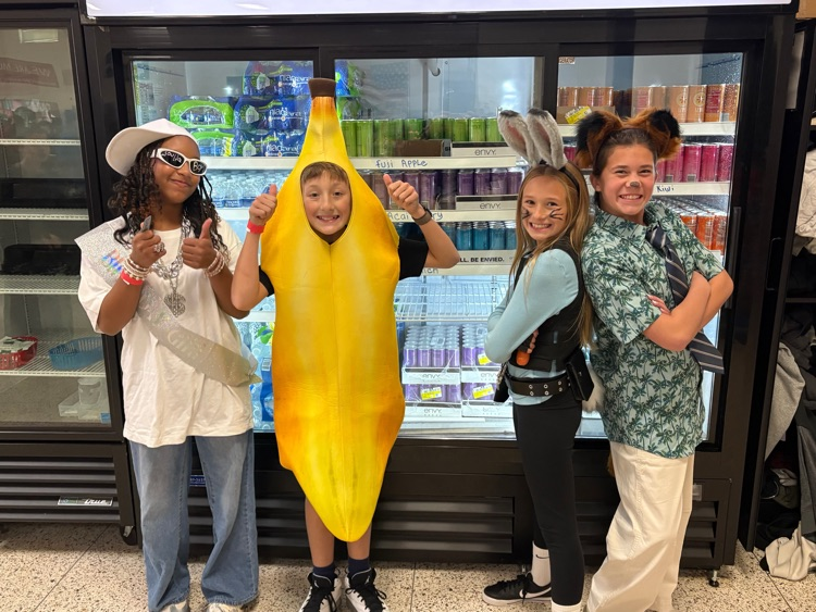 students stand in their costumes 