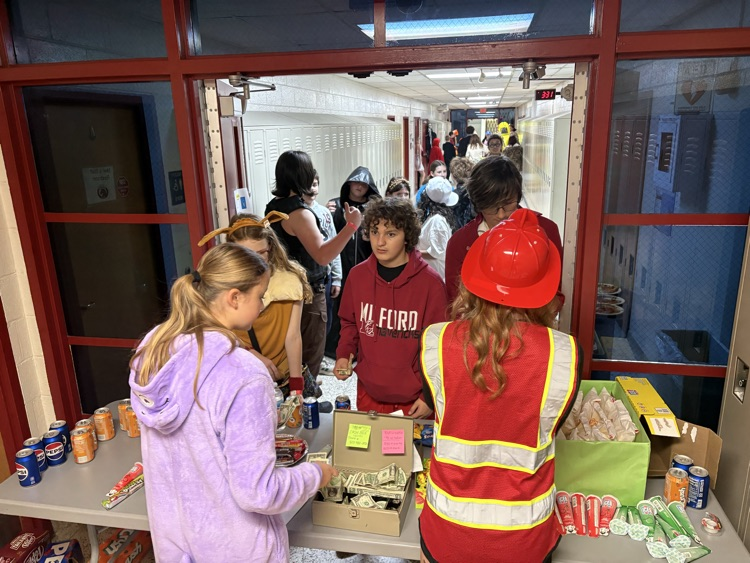 students in costumes buy concessions