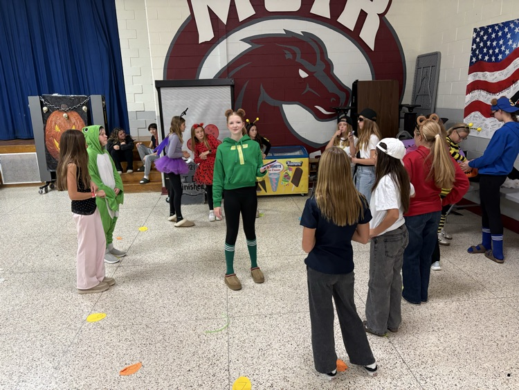 students play games in the cafeteria in costumes 
