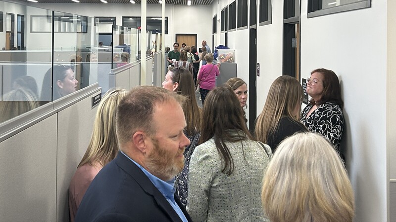 people crowd hallway in new office center