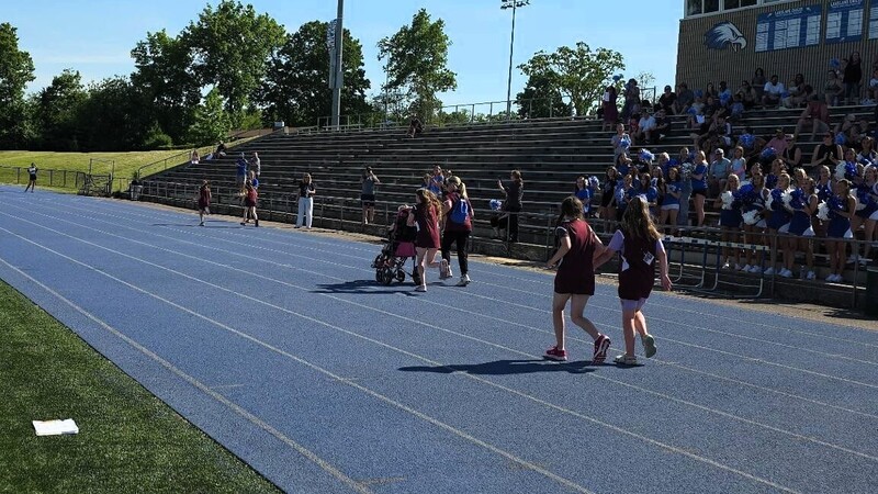 atheltes moving along track durinbg unified race