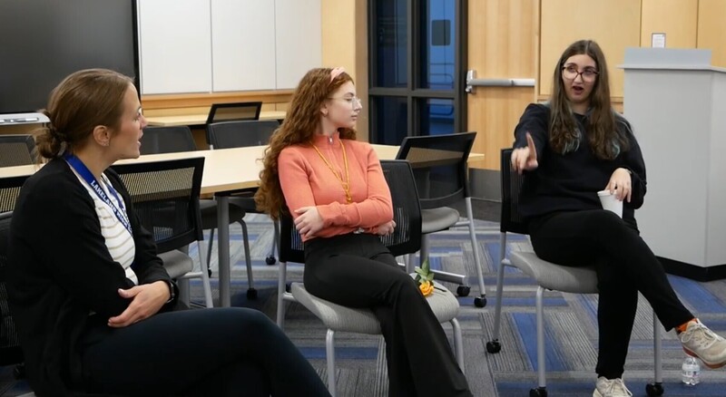 3 students sitting and talking