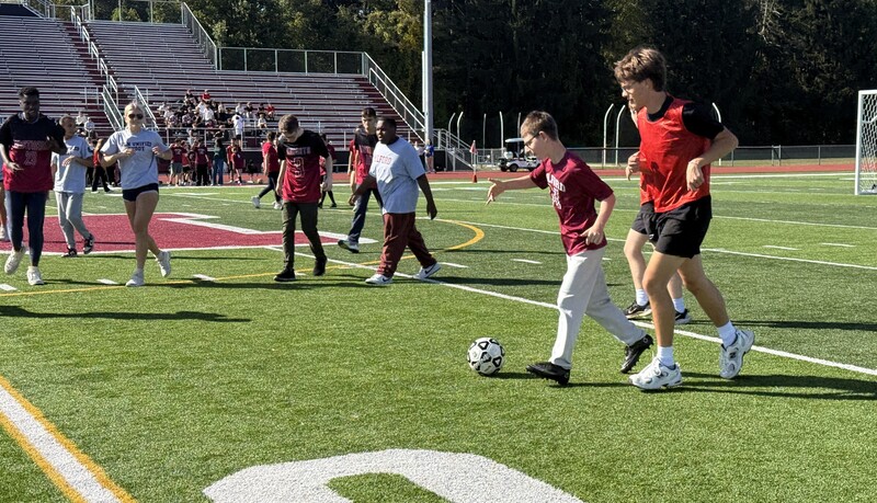 Photo of soccer player on the field with dribbling a ball