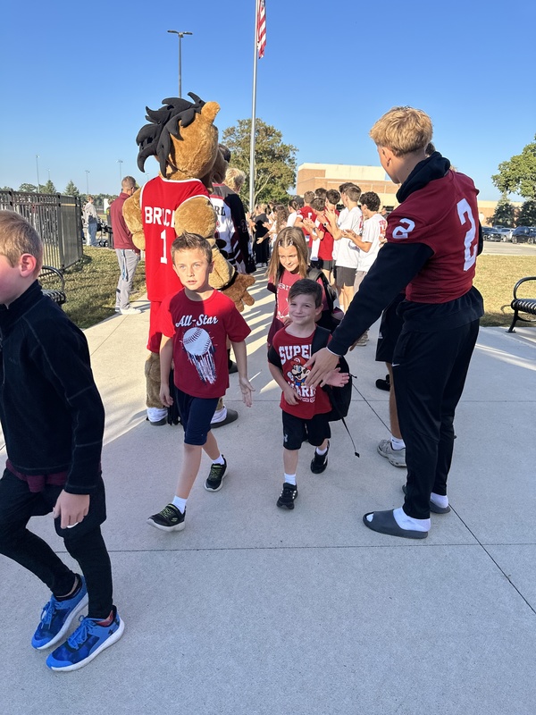 Heritage students being welcomed to school by Milford Students for Hoco2025