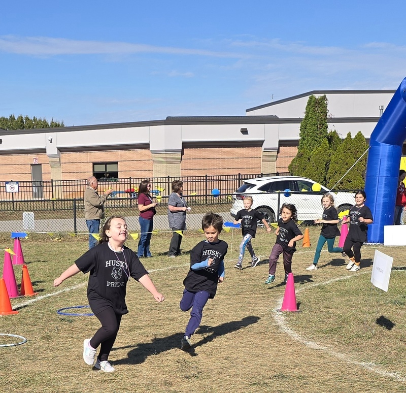 Students running in Fun run and posing.