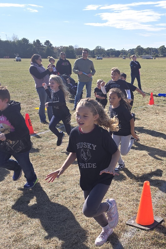 Students running in Fun run and posing.