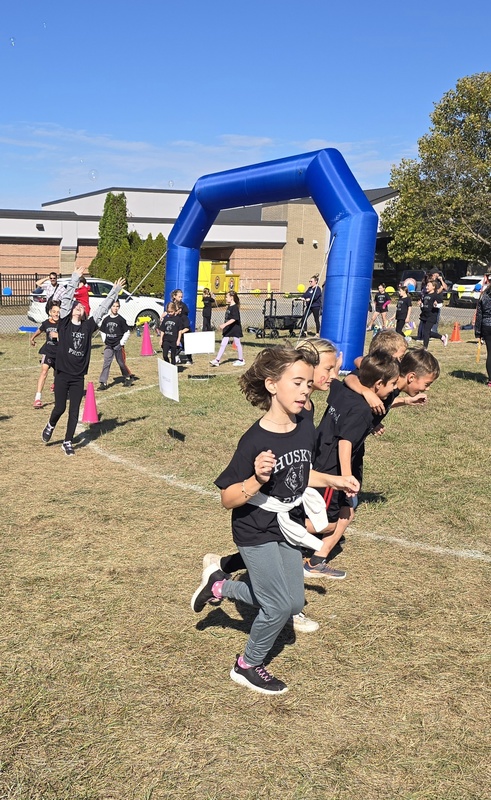 Students running in Fun run and posing.
