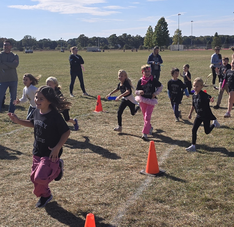 Students running in Fun run and posing.
