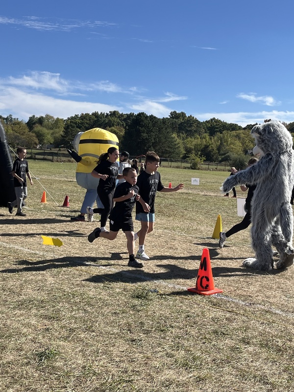 Students running in Fun run and posing.