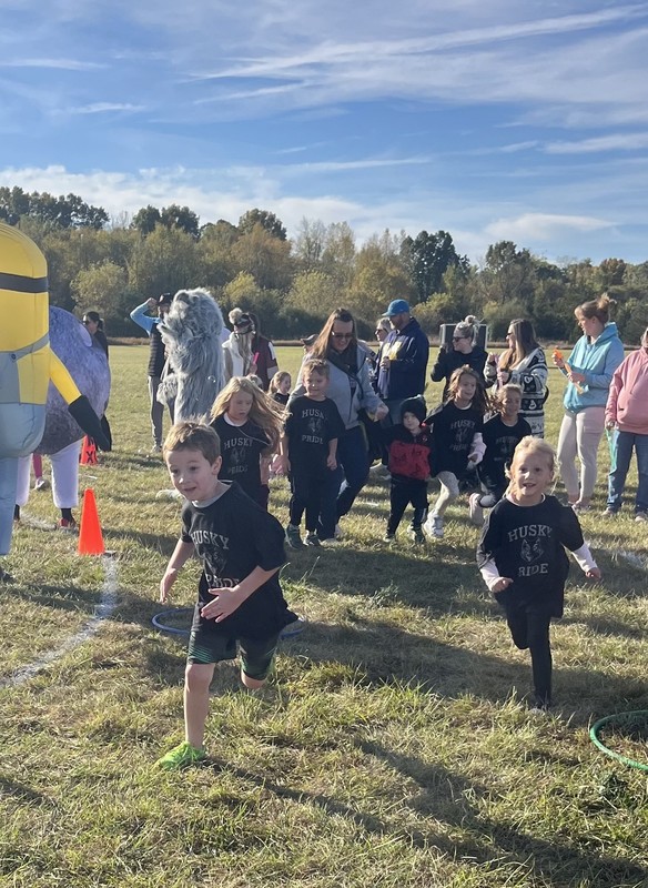 Students running in Fun run and posing.