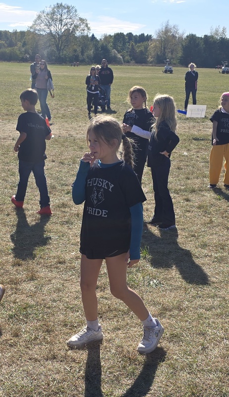 Students running in Fun run and posing.