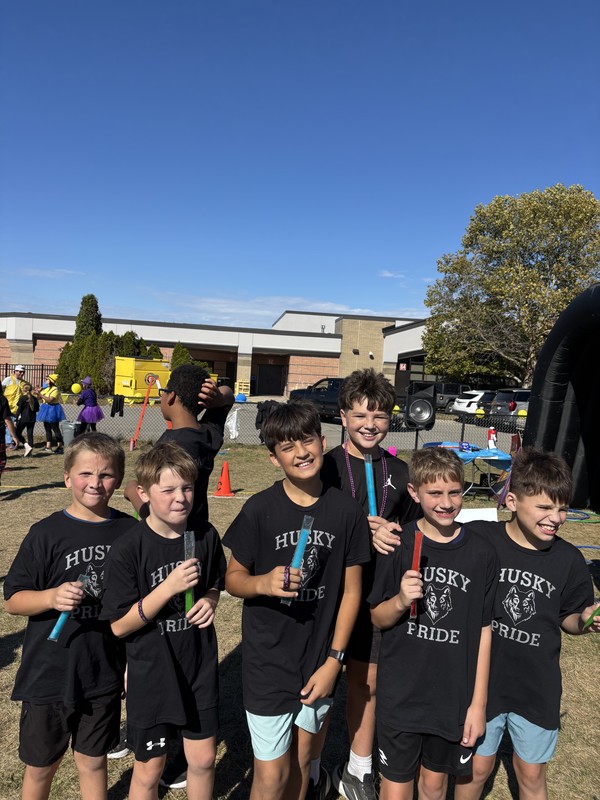 Students running in Fun run and posing.