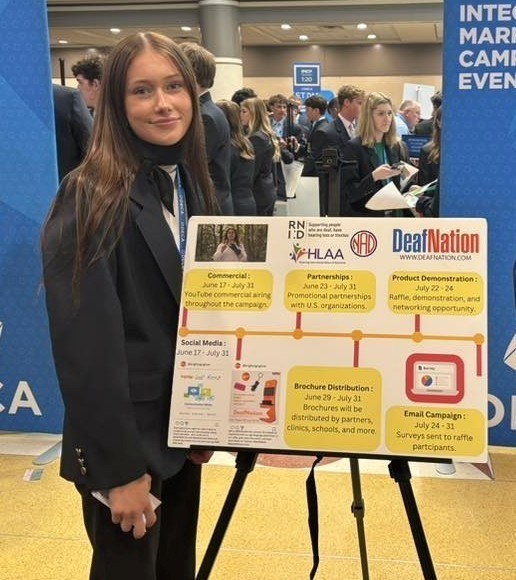 image of Lacey Smith in fron of presentation board at past event