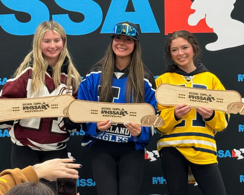 Image of kate hanneman on medal stand after winning state championship