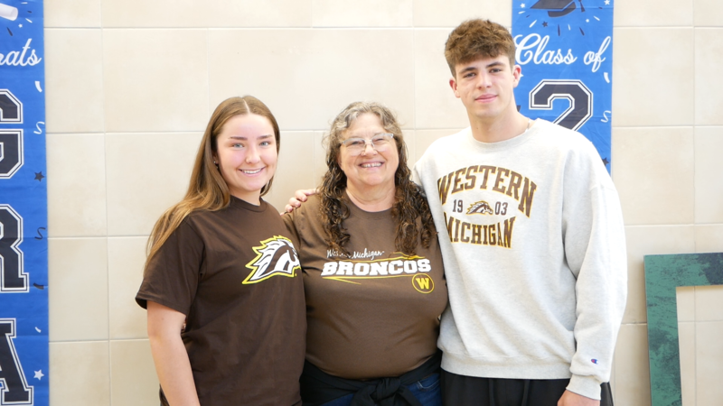 Three students posing for photo in WMU shirts