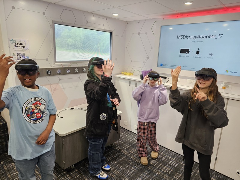 students using VR glasses to study STEM