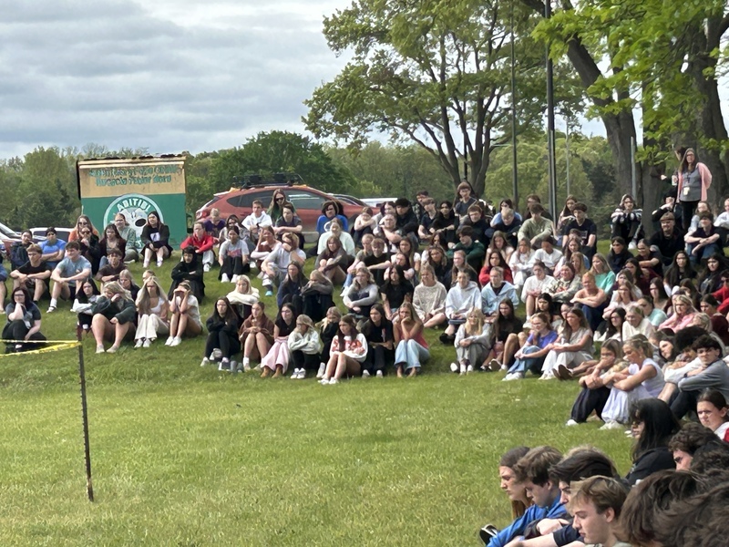 students watching mock car crash simulation event