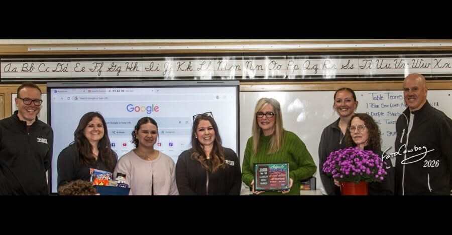 angie rice accepts classroom hero award